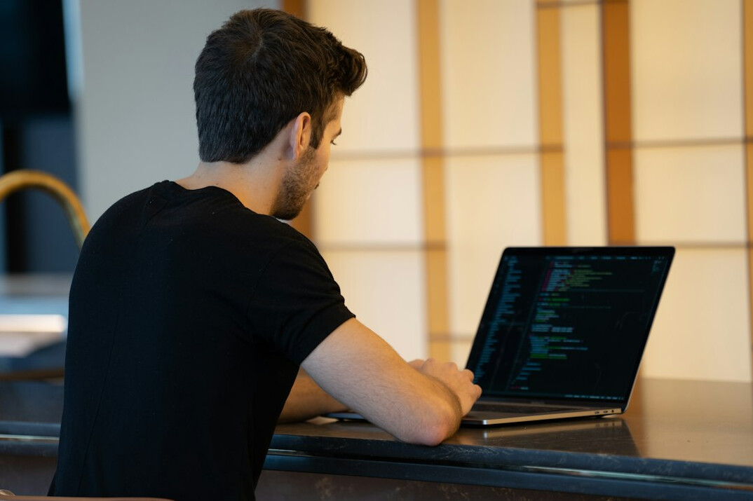 programmer learning coding on laptop