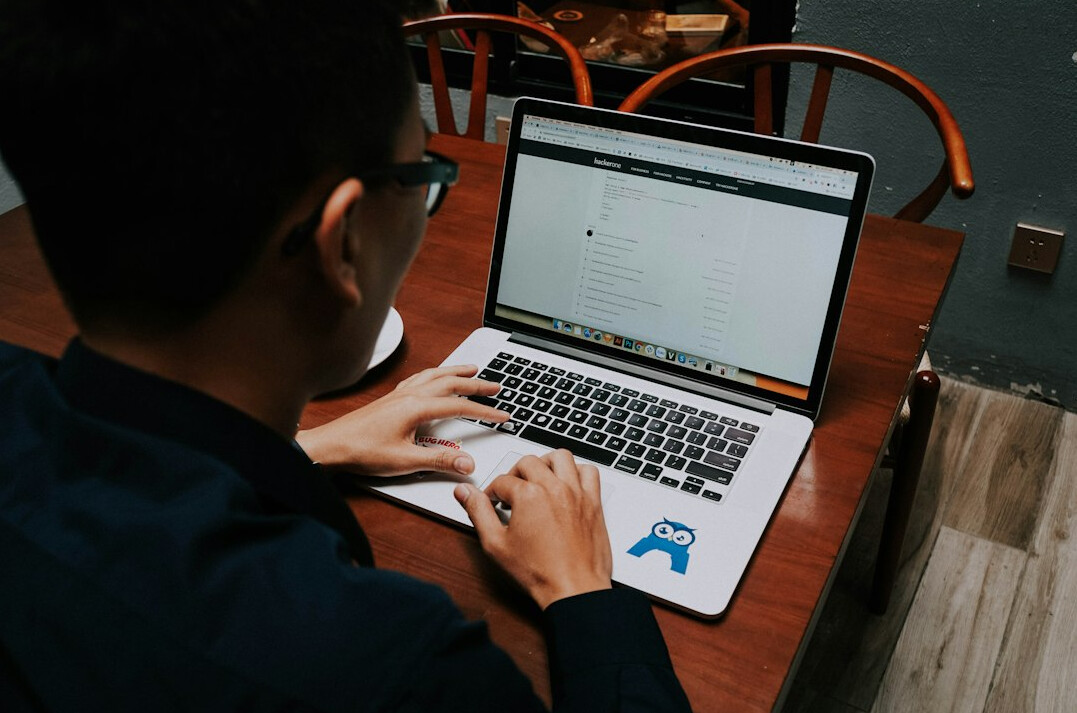 student coding on laptop